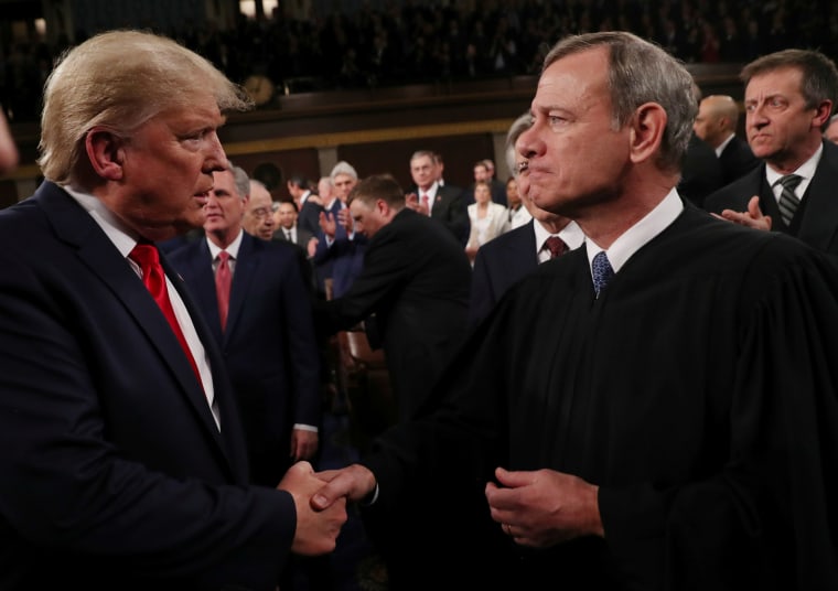 President Donald Trump greets Supreme Court Chief Justice John Roberts as he arrives to deliver his State of the Union address in Washington, D.C., on Feb. 4, 2020.