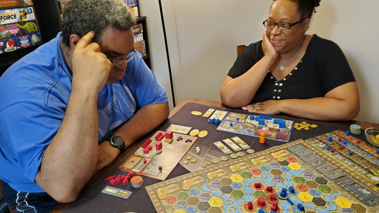 "Mik" Fitch thinks while playing the board game Terra Mystica with his wife Starla.