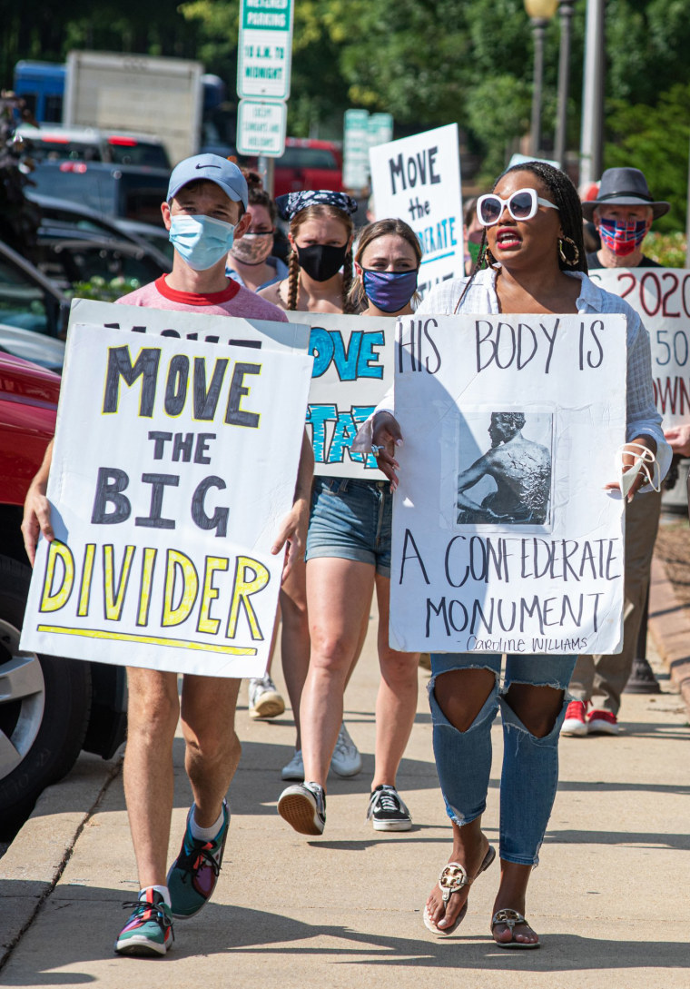 Image: Protesters march as the Lafayette County Board of Supervisors voted to keep a Confederate statue on the grounds of the Lafayette County Courthouse in Oxford, Miss.