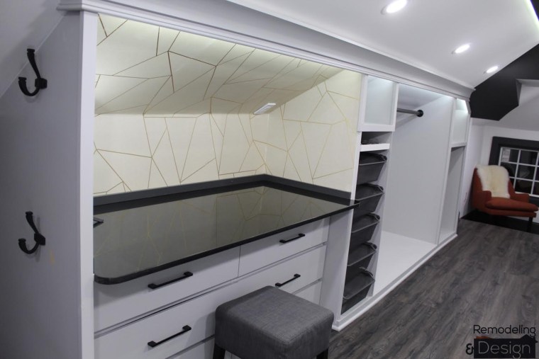 The space includes a vanity and floor-to-ceiling shoe rack. 