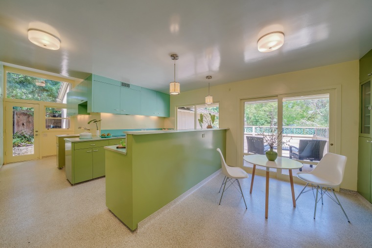The tri-color kitchen and dining area add a pop of color to the house. 