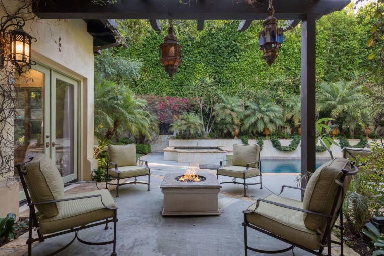 The backyard includes a fire feature with seating for guests.