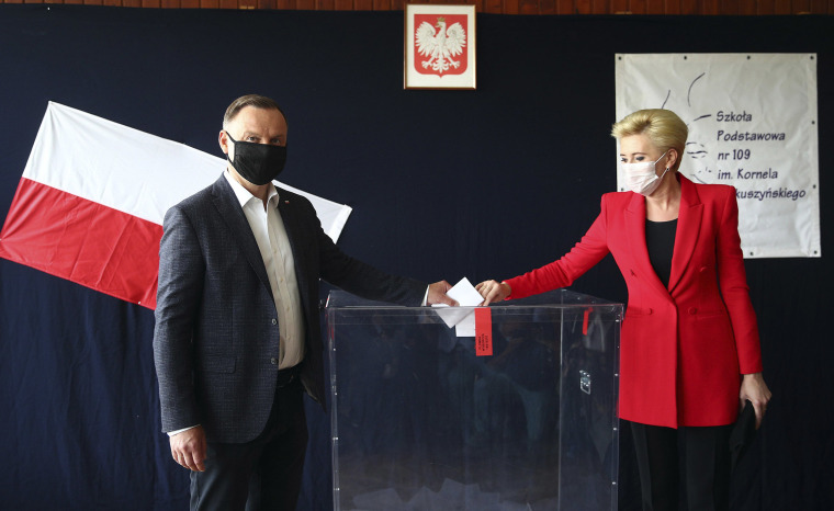 Image: Incumbent President Andrzej Duda and candidate in Poland's presidential election runoff, and first lady Agata Kornhauser-Duda cast their ballots at a polling station in their hometown of Krakow, Poland,