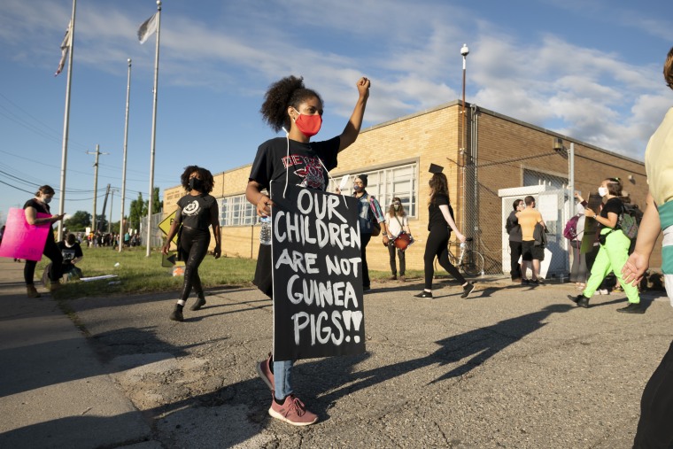 Demonstrators block the driveways of a Detroit school bus terminal to keep buses from running on the first day of summer classes on Monday. 