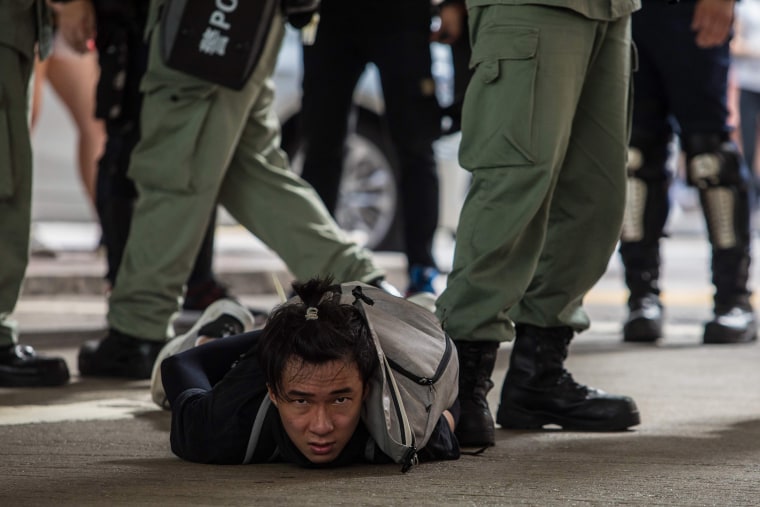 Image: Riot police detain a man as they clear protesters taking part in a rally against a new national security law in Hong Kong