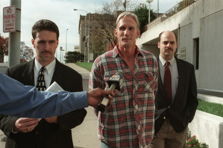 In this 1998 photo, Wesley Ira Purkey, center, is escorted by police officers in Kansas City, Kan., after he was arrested in connection with the death of 80-year-old Mary Ruth Bales.