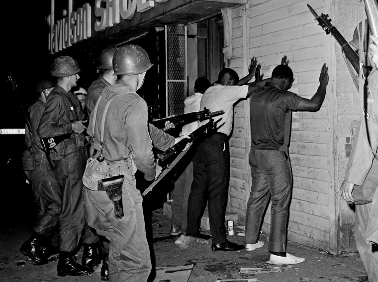 National Guardsmen pointed bayonets at three men arrested during  July 1967 riots in Newark.