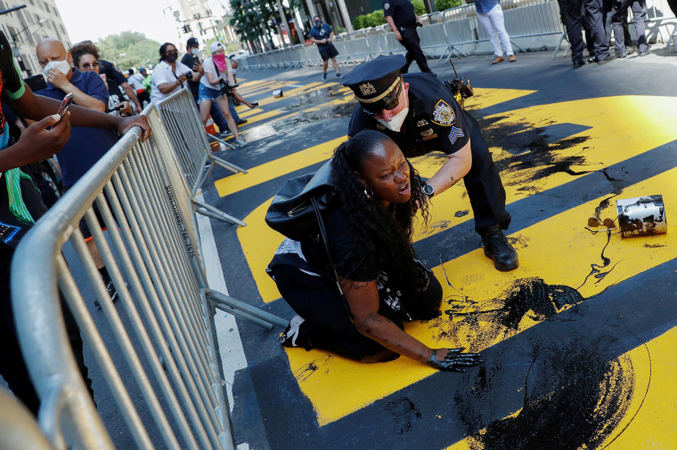 Image: Protesters throw paint on a Black Lives Matter mural outside of Trump Tower on Fifth Avenue in Manhattan, New York