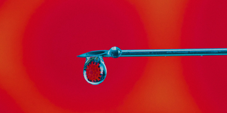 Close-up syringe with coronavirus in a drop. Coronavirus pandemic concept. Vaccine