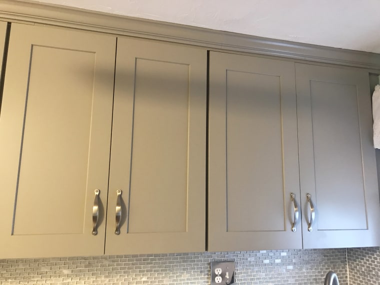 Gray cabinets brighten up our petite kitchen and visually extend the room.