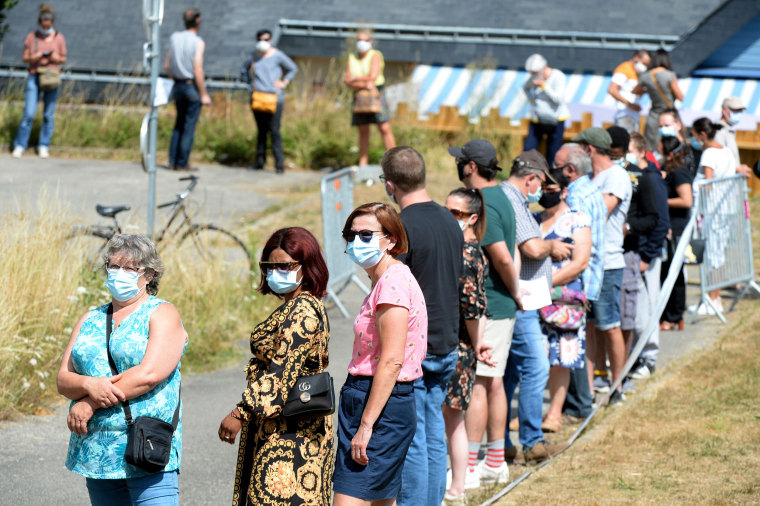 Image: People line up to have a COVID-19 test in Laval, France, as part of a massive testing campaign responding to an outbreak in the area.