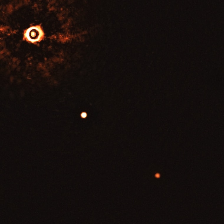 This image, captured by the SPHERE instrument on ESO's Very Large Telescope, shows the star TYC 8998-760-1 accompanied by two giant exoplanets. This is the first time astronomers have directly observed more than one planet orbiting a star similar to the Sun.