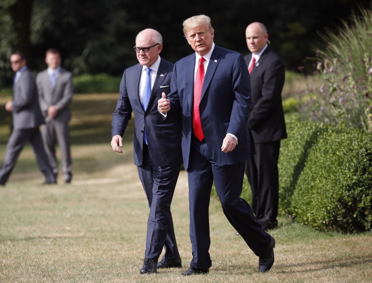 President Donald Trump walks with U.S. ambassador to Britain Woody Johnson before boarding Marine One in London on July 13, 2018.