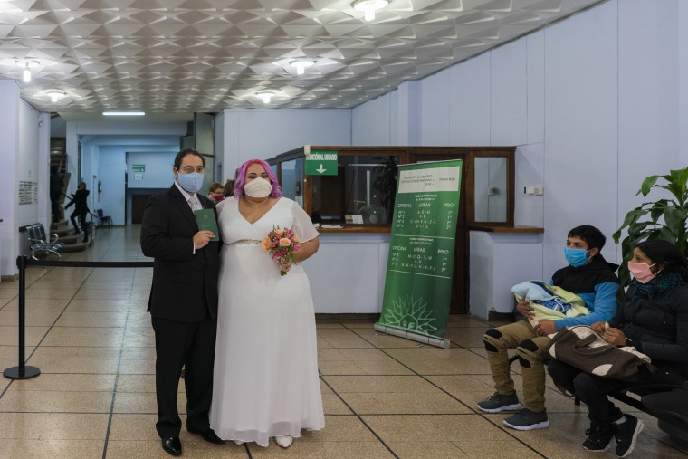 Newlyweds Mauricio Musso and Natalia Perera pose for a photo after they were married at the civil registry office, amid the pandemic, in downtown Montevideo, Uruguay, Friday, May 15, 2020.