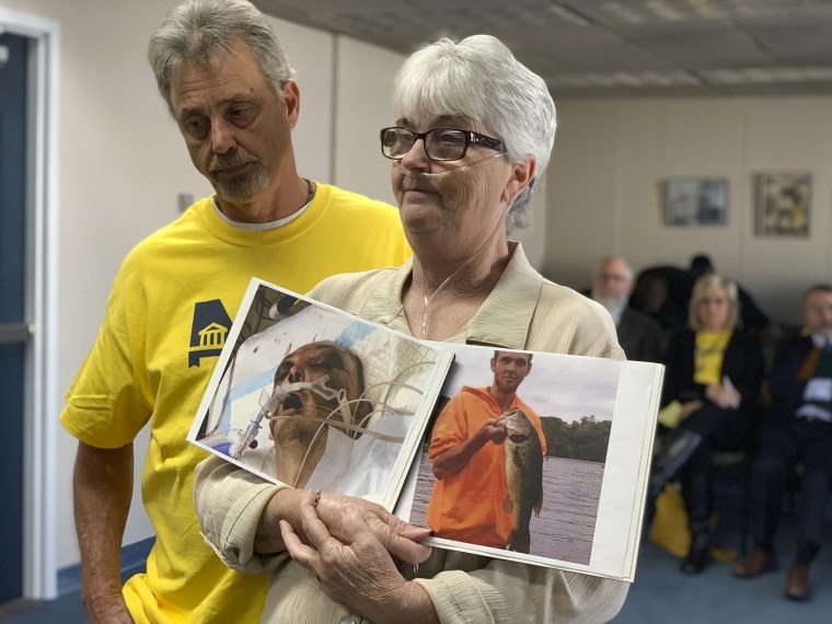 Sandy Ray holds photos of her son, Steven Davis, during a press conference at the Alabama Statehouse in Montgomery on Dec. 4, 2019. Davis died in 2019 after an altercation with corrections officers at the prison where he was incarcerated.