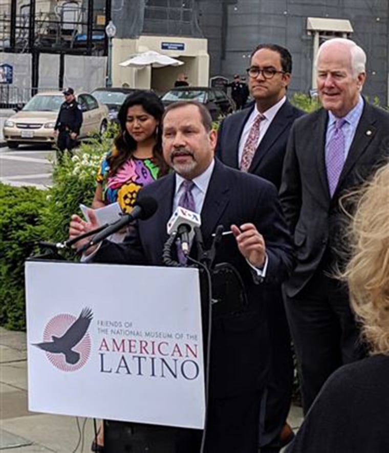Danny Vargas speaks about the National Museum of the American Latino as several Latino legislators and others, including Sen. Jon Cornyn, R-TX, right, and others listen, in Washington in May 2019.