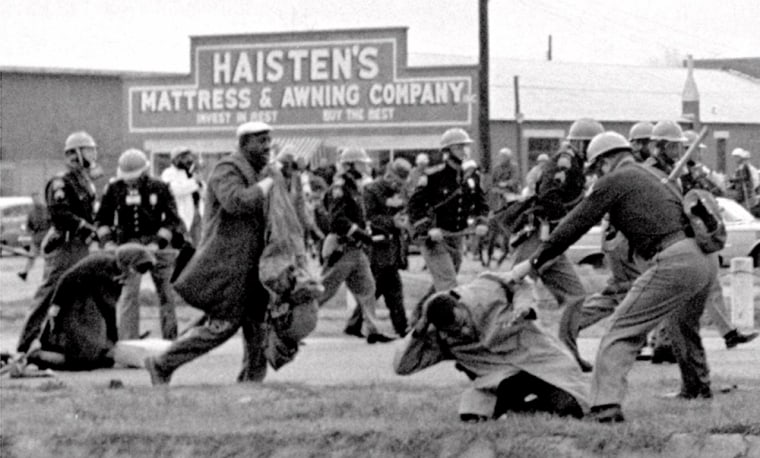 Image: Alabama state troopers swing nightsticks to break up a civil rights voting march