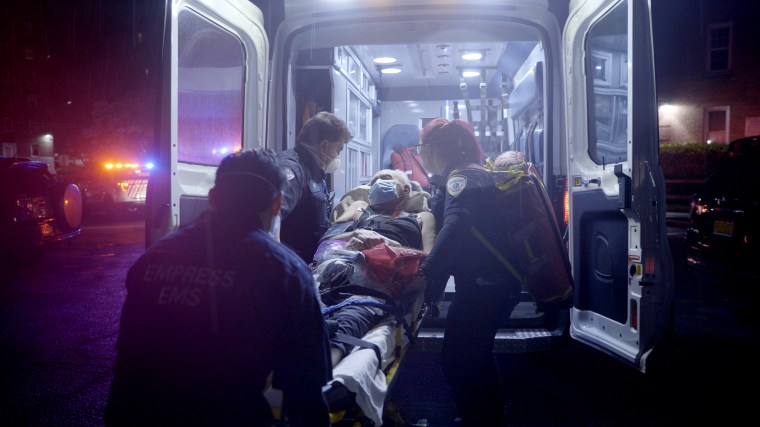 A patient is put in an ambulance by EMT's in Yonkers, N.Y., on April 30, 2020.