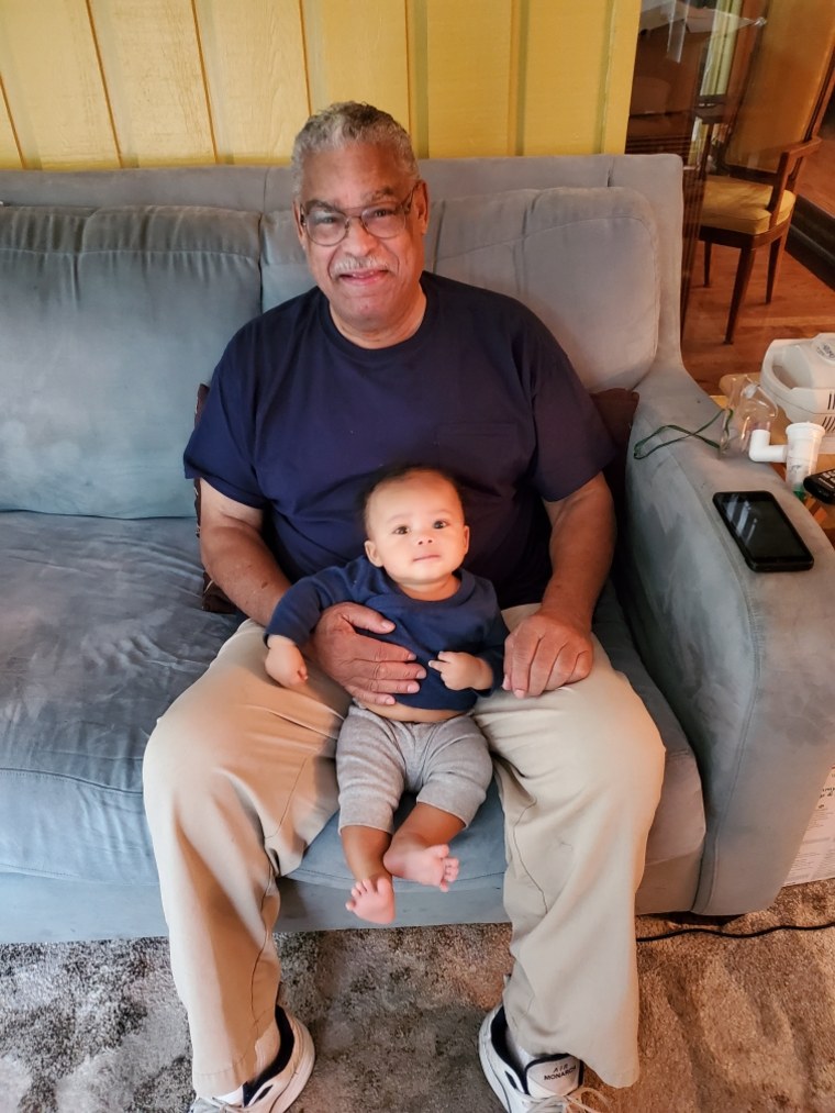 Chloe Cook's father, Martel Cook, holds her infant son, Cannon, at their last pre-coronavirus visit in December 2019.
