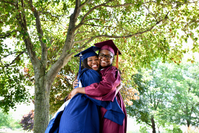 Quiana Cohn hugs her daughter, India. Both arewearing their graduation caps and gowns.