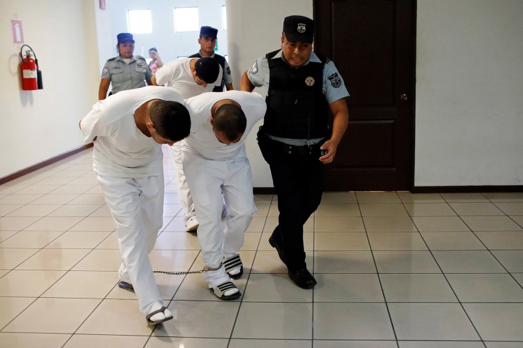 Image: Three former police officers are taken to a hearing as they face charges for aggravated homicide and the kidnapping of Camila Diaz Cordova, a transgender woman under their custody