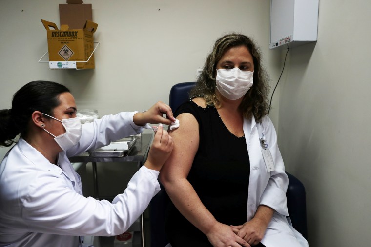 A nurse administers China's SinoVac coronavirus potential vaccine to a volunteer in Sao Paulo, Brazil, on July 30, 2020.