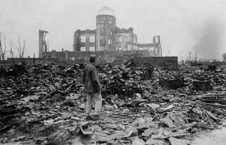 Image: A correspondent stands in the rubble in Hiroshima on Sept. 8, 1945, a month after the first atomic bomb ever used in warfare was dropped by the U.S.