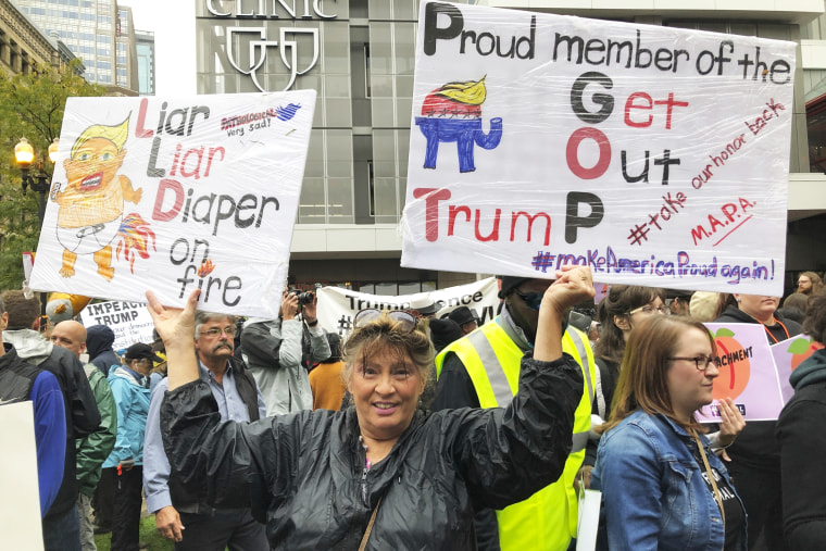 Lora Torgerson of Inver Grove Heights, Minn., protests outside Target Center in Minneapolis ahead of President Donald Trump's rally there on Oct. 10, 2019.