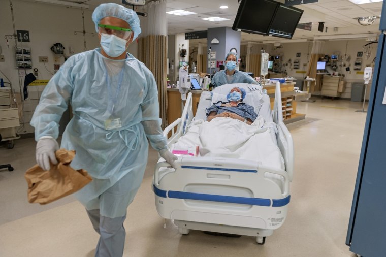 Members of the transplant anesthesiology team, Drs. Kamen V. Vlassakov front, and Lindsay Wahl lead Carmen Blandin Tarleton to the operating room for her second face transplant at Brigham and Women's Hospital in Boston on July 28, 2020.