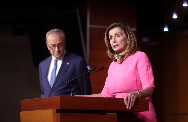 Image: U.S. House Speaker Nancy Pelosi (D-CA), speaks next to Senate Minority Leader Chuck Schumer (D-NY), during a news conference on Capitol Hill in Washington
