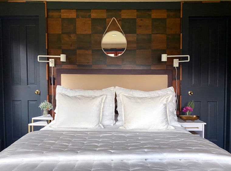 Wood is used to create the checkerboard look on this bedroom wall.