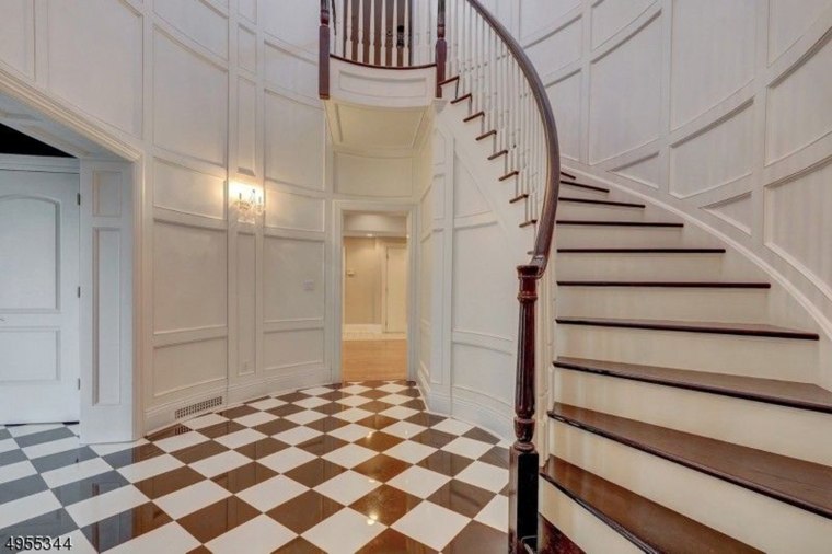 The foyer floor is made of marble.