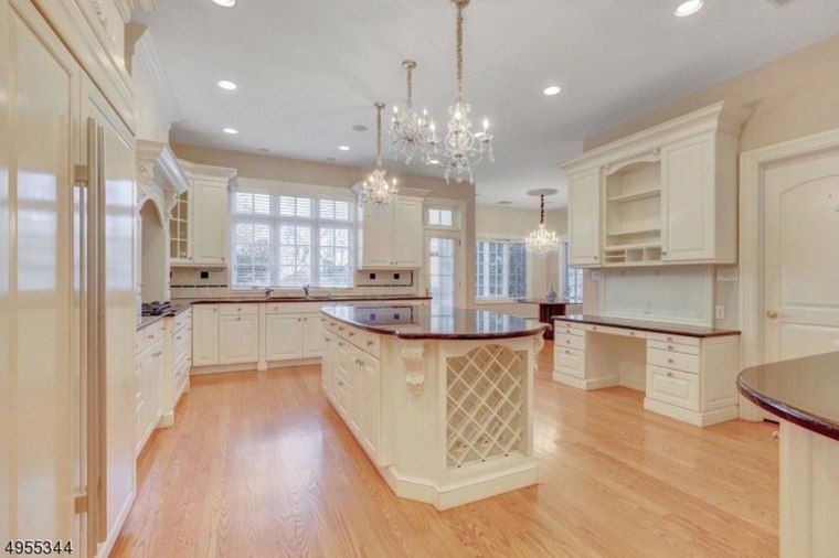 The spacious kitchen is outfitted with custom cabinets and an oversized island.