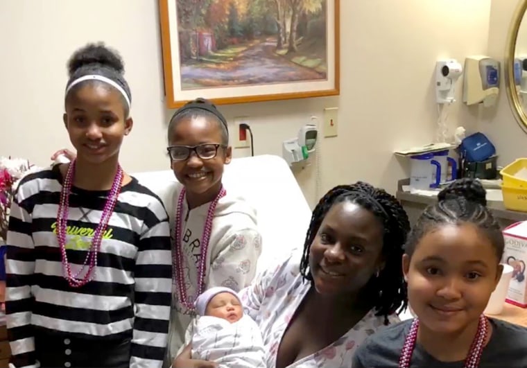 Erin King-Mullins with her stepdaughters and her newborn daughter, McKenzie. 