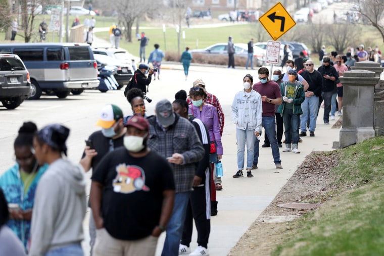 Image: Voters wait in line outside Riverside University High School to cast ballots during the presidential primary election in Milwaukee, Wisconsin.