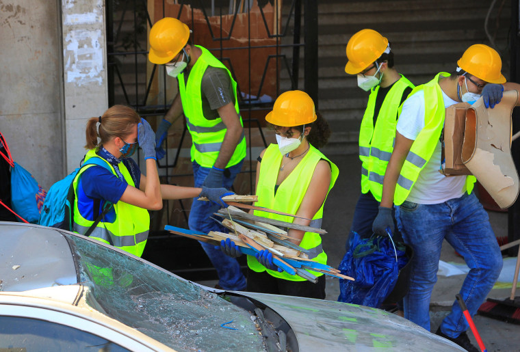 Image: Volunteers clean debris