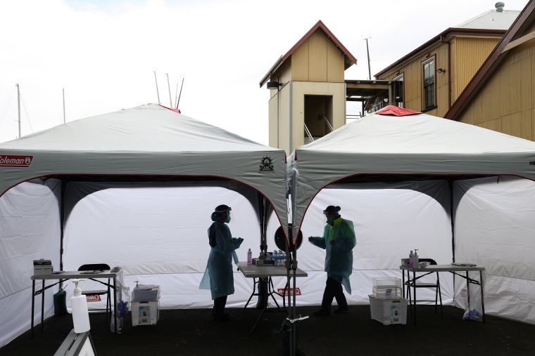 Image: Medical workers are seen at a COVID-19 pop-up testing centre in Sydney