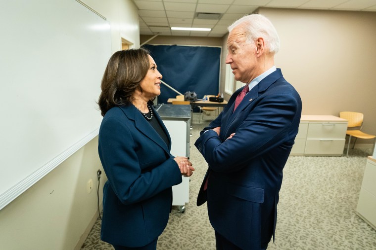 Sen. Kamala Harris, D-Calif., speaks with Joe Biden before a campaign rally at Renaissance High School on March 9, 2020 in Detroit.