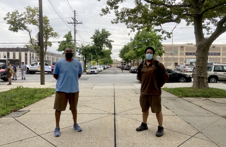 Dave Cockrel and Basil Darling, UPS drivers and union shop stewards, stand outside their UPS facility in Brooklyn, N.Y. UPS has seen booming business during the pandemic, but workers say long days and hundreds of deliveries have left them exhausted.