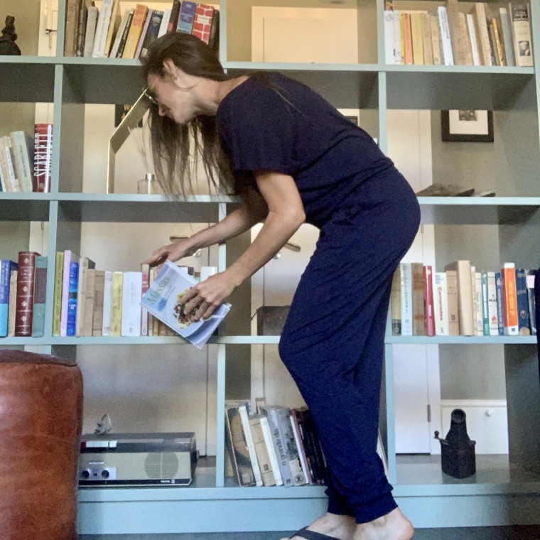 Picking out a book while wearing my off-shoulder jumpsuit