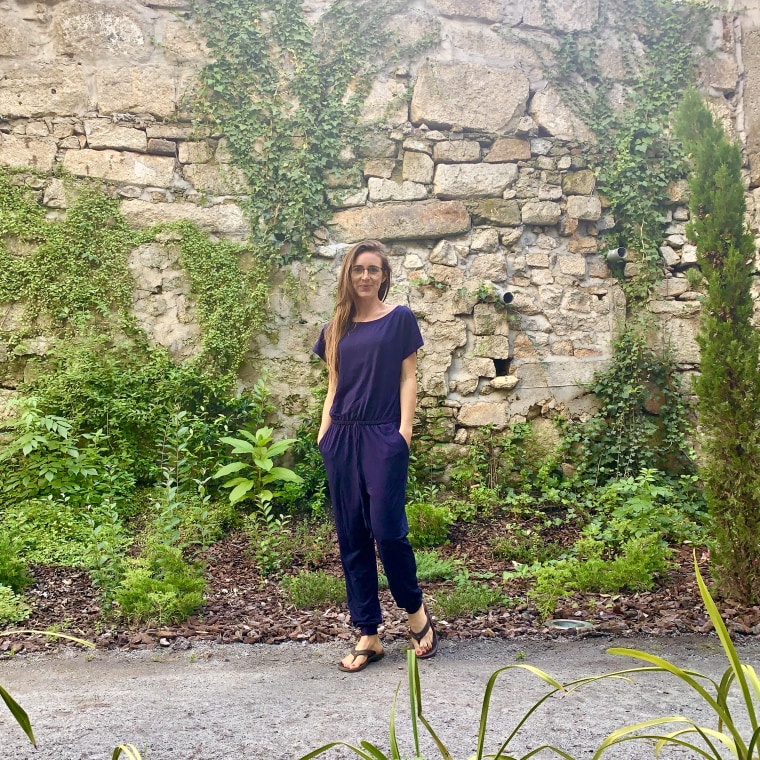 Wearing my off-shoulder jumpsuit in the courtyard of my hotel