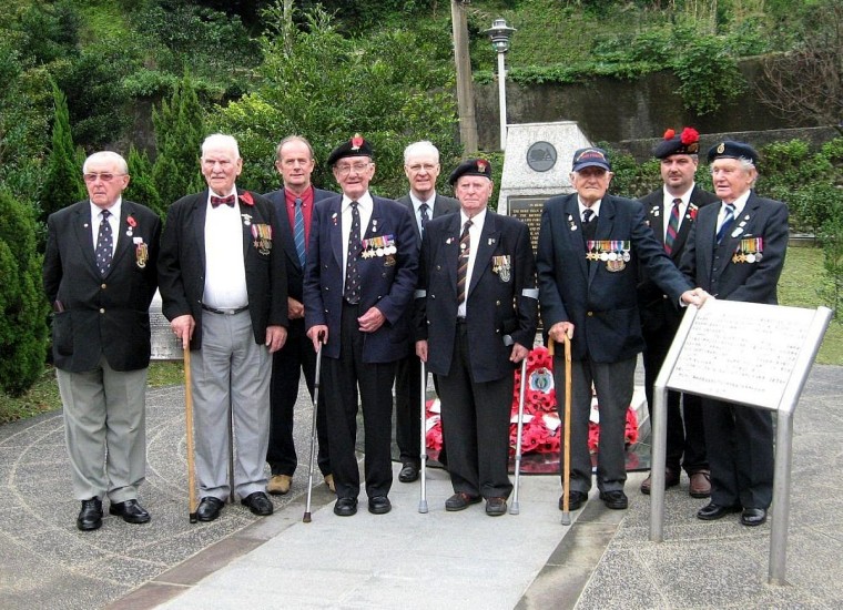 Michael Hurst, center back, with former POWs revisiting a former Japanese camp in Taiwan.