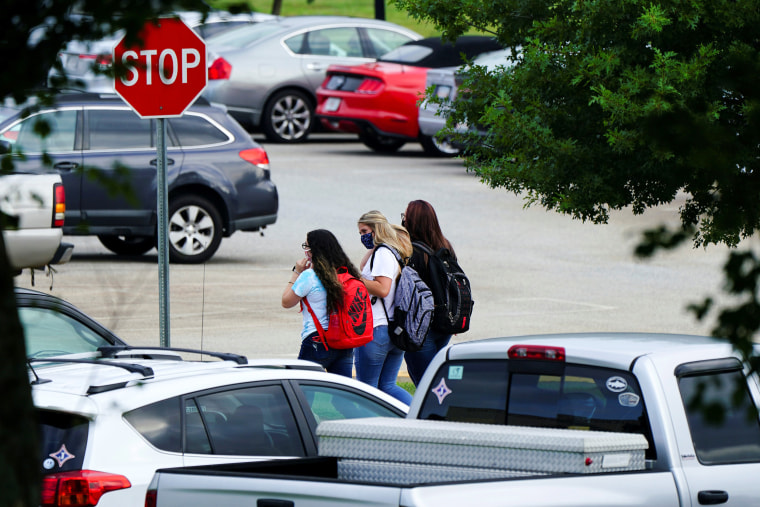Image: Students are seen in the Jefferson High School parking lot as school started amid coronavirus disease (COVID-19) jitters in Jefferson