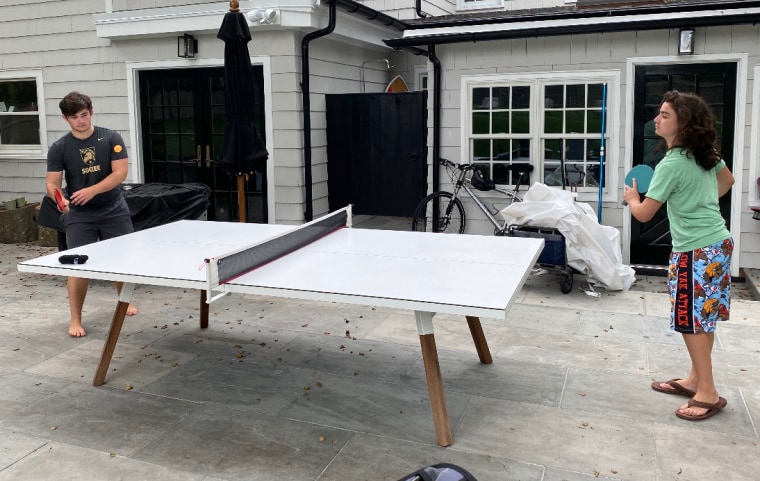 Kyle Glick, 16, a high school junior and his brother Slate, 13, an eighth grader, take a study break by playing ping pong.