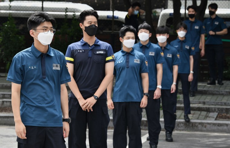 Image: South Korean police officers wait in line to take tests for the COVID-19 coronavirus at Seoul Metropolitan Police Agency's maneuver headquarters in Seoul