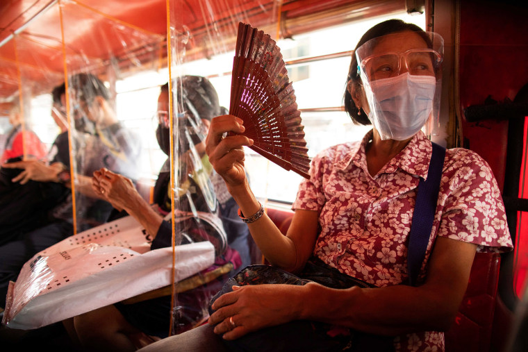 Image: Jeepney passengers seated in between plastic barriers, wear face masks and face shields mandatory in public transportation, to help curb coronavirus disease (COVID-19) infections, in Quezon City, Metro Manila, Philippines,