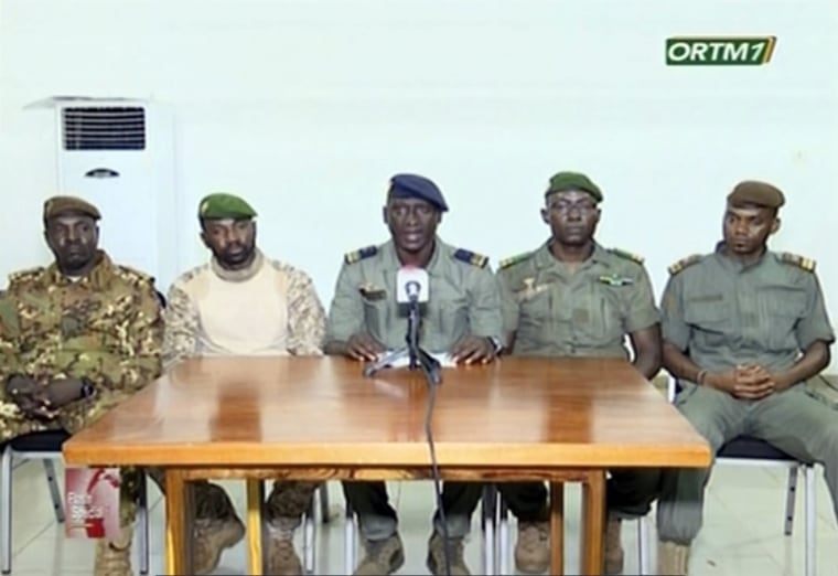 Image: Speaking on national broadcaster ORTM TV, Colonel-Major Ismael Wague, centre, spokesman for the soldiers identifying themselves as National Committee for the Salvation of the People, announce that they have assumed control of Mali