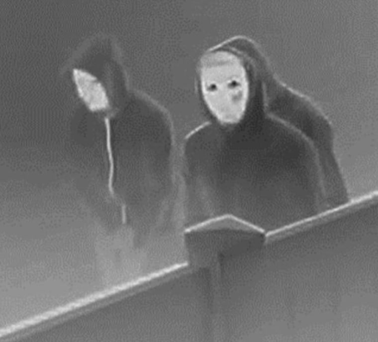 Image: Masked suspects believed to have intentionally set fire that killed a family of five
