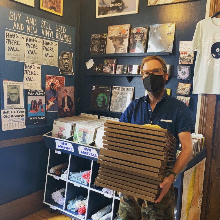 David Swider carries boxed up records ready to be picked up by the U.S. Postal Service at his store The End of All Music in Oxford, Miss.