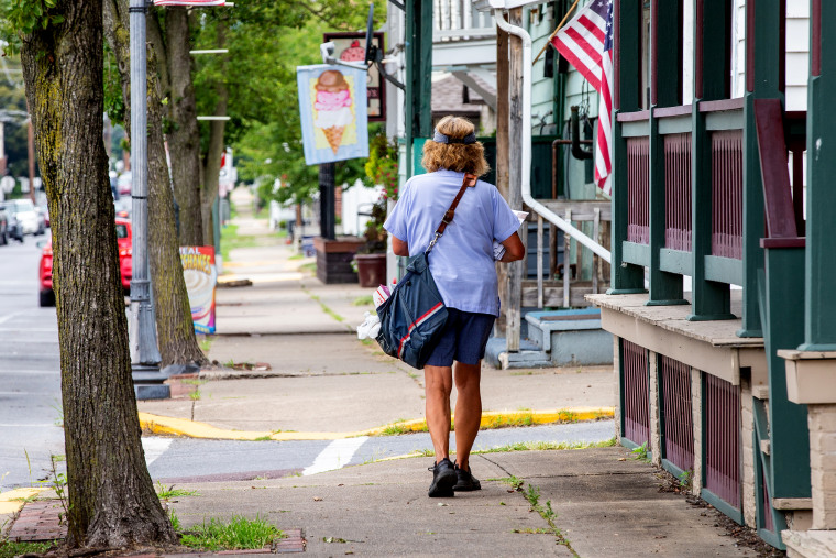 A United States Postal Service letter carrier walks her